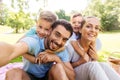 Family having picnic and taking selfie at park