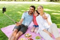 Family having picnic and taking selfie at park