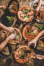 Family having pizza dinner party with red wine, top view Royalty Free Stock Photo