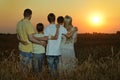 Family having rest in field