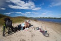 Family having a rest on a river coast Royalty Free Stock Photo