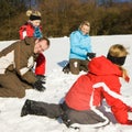 Family having a snowball fight Royalty Free Stock Photo