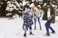 Family having a snowball fight in the snow Royalty Free Stock Photo