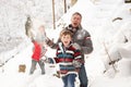 Family Having Snowball Fight In Snowy Landscape Royalty Free Stock Photo