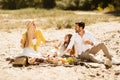 Family Having Summer Picnic Sitting On Blanket Talking In Countryside Royalty Free Stock Photo