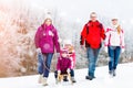 Family having winter walk in snow with sled Royalty Free Stock Photo