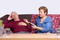 Family health care. Emergency call. Worried stressed depressed senior man. Elderly woman using mobile phone calling help Royalty Free Stock Photo