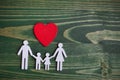 Family health, life insurance concept. Wooden chain in form of family with red heart. Top view, flat lay Royalty Free Stock Photo