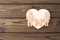 Family, heart on a wooden background.