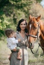 Family with her horse on a lovely meadow lit by warm evening light. Animal love concept Royalty Free Stock Photo