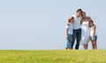 Family on herb under blue sky Royalty Free Stock Photo