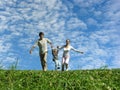 Family on herb under blue sky Royalty Free Stock Photo