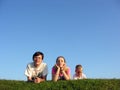 Family on herb under sky 2 Royalty Free Stock Photo