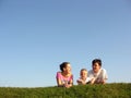 Family on herb under sky Royalty Free Stock Photo