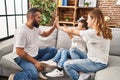 Family high five with hands raised up sitting on sofa at home Royalty Free Stock Photo