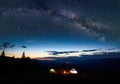 Family hikers having a rest at night camping in mountains Royalty Free Stock Photo