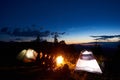 Family hikers having a rest at night camping in mountains