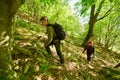 Family of hikers walking on a mountain trail Royalty Free Stock Photo