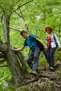 Family of hikers walking on a mountain trail Royalty Free Stock Photo