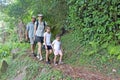 Family hiking the Cross Island Track in the rain forest of a tropical pacific island