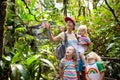 Family hiking in jungle. Royalty Free Stock Photo