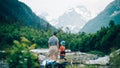 Family hiking in the mountains. A young mother and her son hike together in the mountains on a beautiful summer evening