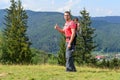 Family hiking in nature. A father carries his son in a backpack high among the hills and forest