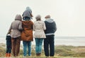 Family hiking outdoor, generations at beach together with nature view and back, spending quality time in winter Royalty Free Stock Photo