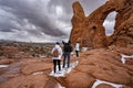 Family hiking in red mountains in Utah during winter.