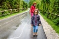 Family hiking on road in nature on a rainy day Royalty Free Stock Photo