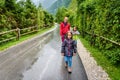 Family hiking on road in nature on a rainy day