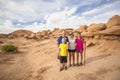 Family hiking together among desert red rock formations at Goblin Valley Royalty Free Stock Photo