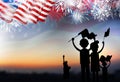 Family holding american flag with fireworks Royalty Free Stock Photo