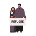 Family holding banner with refugee teks. World refugee day Concept. Stateless refugee family war victims. Middle eastern muslim