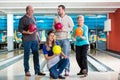 Family holding colorful bowling ball Royalty Free Stock Photo