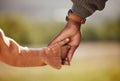 Family, holding hands and girl with father closeup in a park, hands and walking in nature, bond and relax outdoors. Love