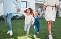 Family, holding hands and kids running with their parents outdoor in the garden of their home together. Children, fun Royalty Free Stock Photo