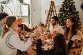 Family holding hands and praying before eating Christmas dinner Royalty Free Stock Photo