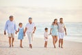 Family, holding hands and walk on beach, generations and people travel together, grandparents and parents with kids Royalty Free Stock Photo