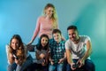 Family holding joysticks and start virtual game