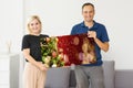 family holding photo canvas with christmas picture