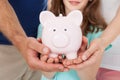 Family holding piggy bank