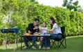 Family holiday activities include father, mother and children with camping barbecue and play in the yard together happily on