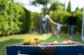 Family holiday activities include father, mother and children with camping barbecue and play in the yard together happily on