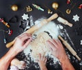 Top view of fathers and kids hands making Christmas tree cookies Royalty Free Stock Photo