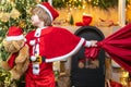 Family holiday. Boy child play near christmas tree. Wish to meet santa claus. Santa Claus helper carrying big bag full Royalty Free Stock Photo