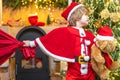 Family holiday. Boy child play near christmas tree. Wish to meet santa claus. Santa Claus helper carrying big bag full Royalty Free Stock Photo