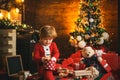 Family holiday. Childhood memories. Santa boy celebrate christmas at home. Boy child play near christmas tree. Merry and