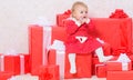 Family holiday. Little baby girl play near pile of gift boxes. Gifts for child first christmas. Celebrate first Royalty Free Stock Photo