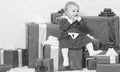 Family holiday. Little baby girl play near pile of gift boxes. Gifts for child first christmas. Celebrate first Royalty Free Stock Photo